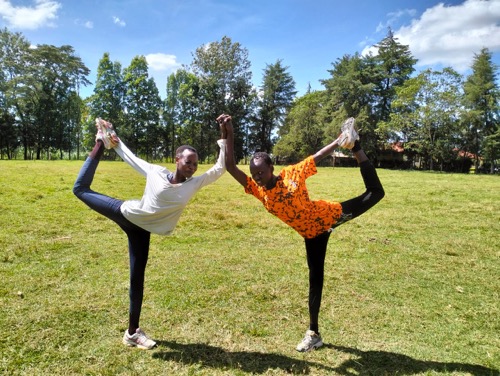 Photo of two runners stretching